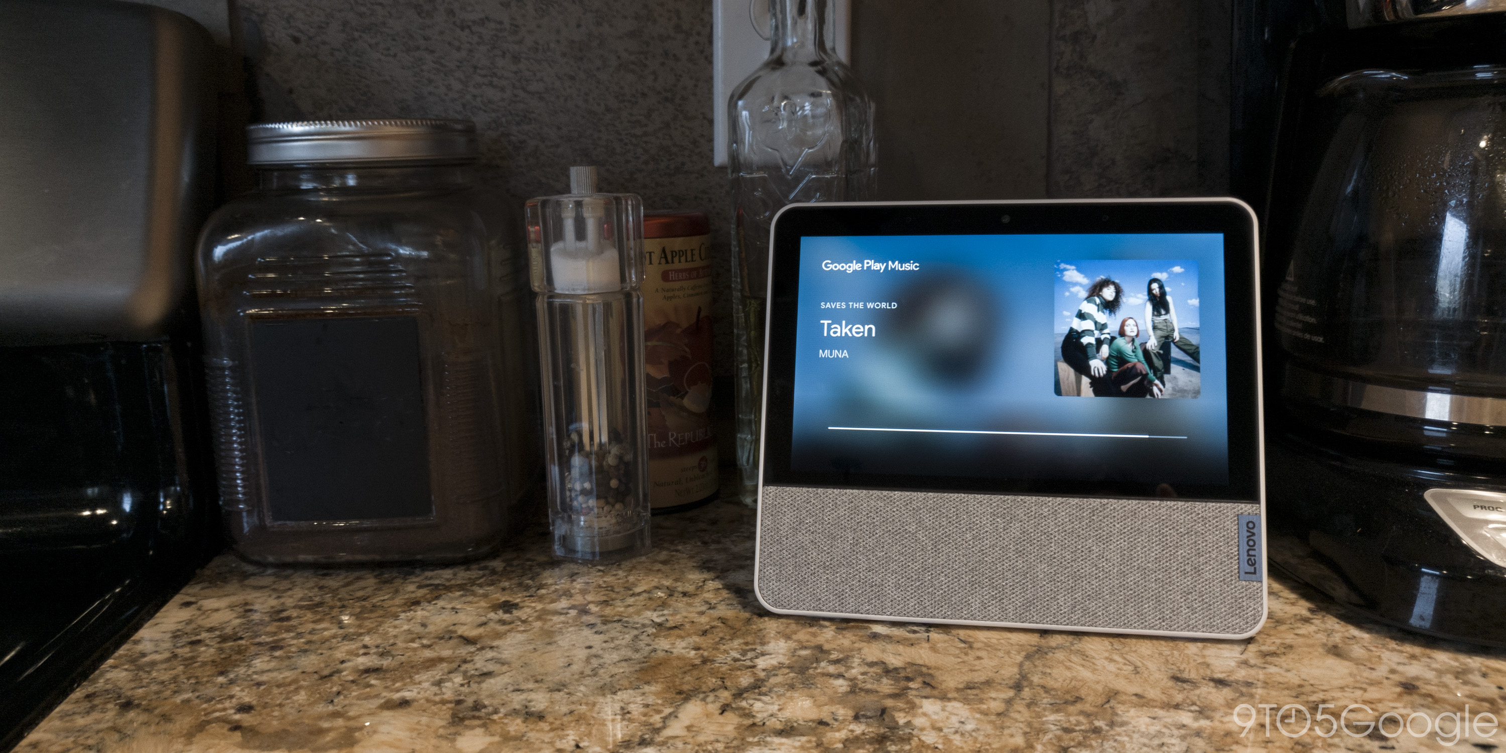 The Smart Display sitting on a kitchen countertop and playing the song "Taken" by MUNA.