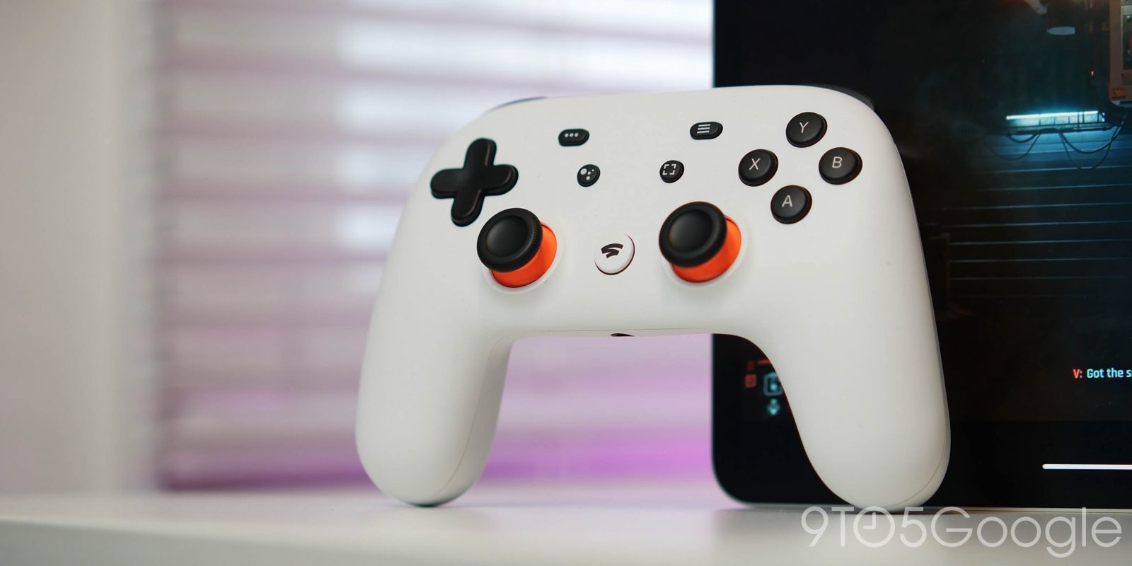 Clearly White Stadia Controller leaning against an Android device