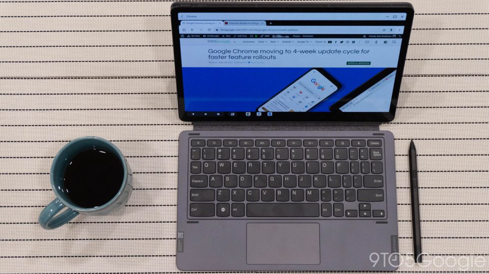 Lenovo P11 Pro tablet with keyboard cover, stylus, and a cup of coffee