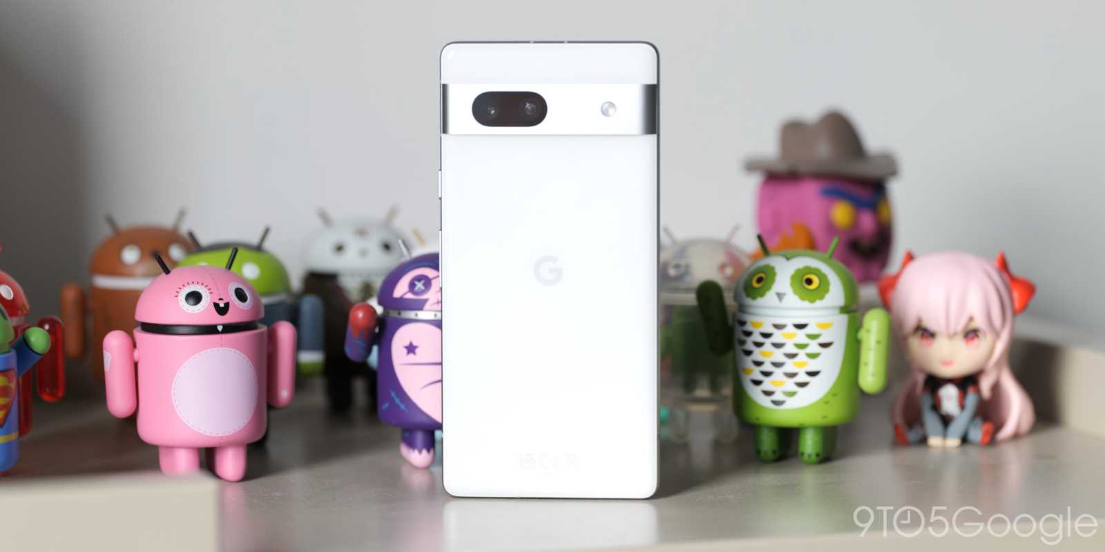 Pixel 7a surrounded by Android figurines